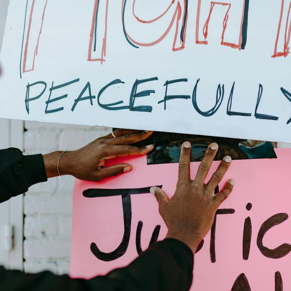 Person meditating peacefully in a natural setting with calm lighting.
